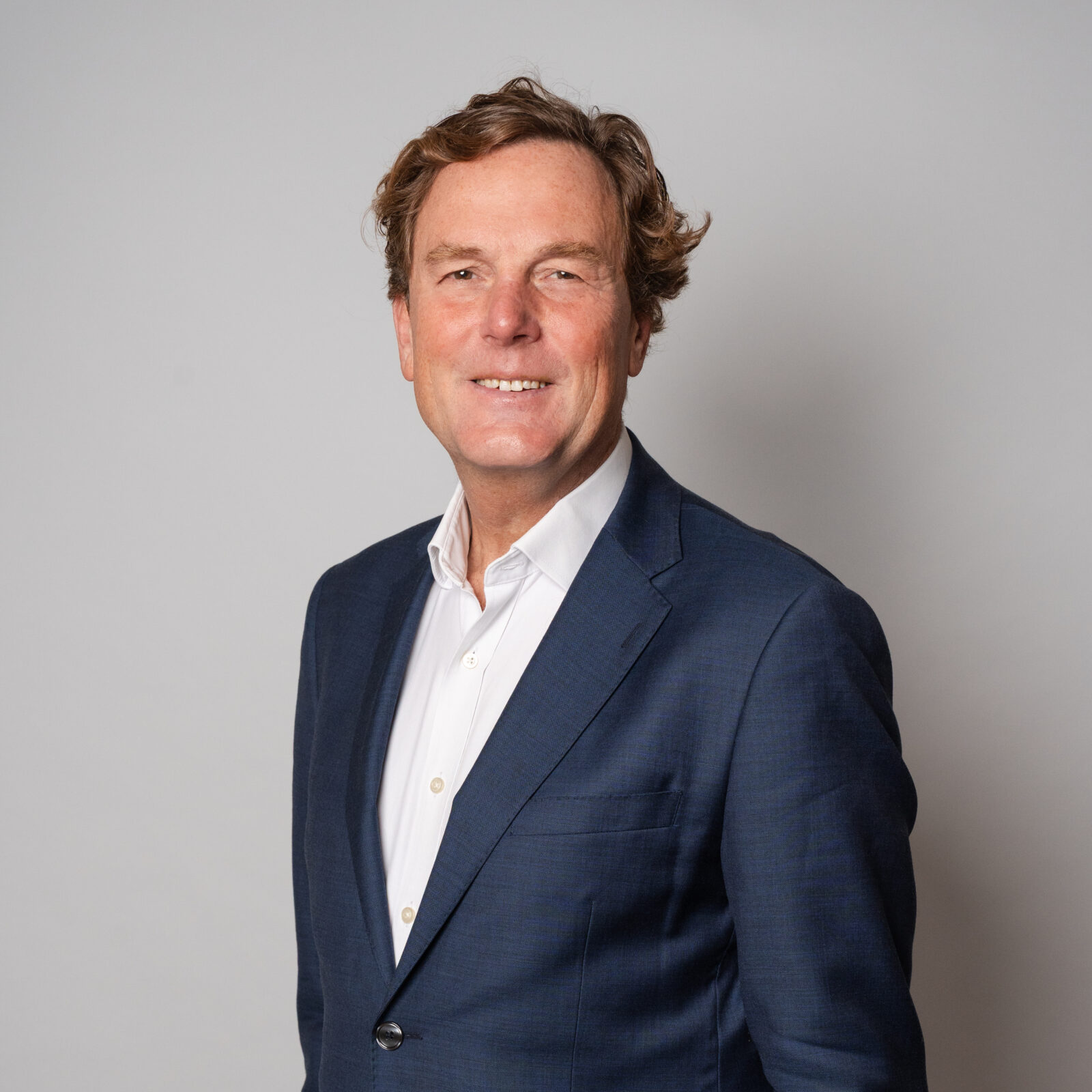Zakelijk portret van algemeen directeur Arjan Bol in colbert en overhemd tegen een neutrale achtergrond